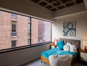 Harrisburg apartment for rent - a bedroom with a bed and a large window