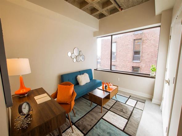 Harrisburg apartment for rent - a living room with a blue couch and a large window