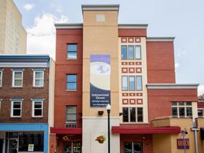 Harrisburg apartment for rent - a large brick building with a clock on the side of it stock photography