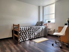 Harrisburg apartment for rent - a bedroom with a bed and a chair and a window