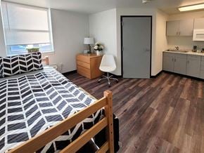 Harrisburg apartment for rent - a bedroom with a bed and a sink and a door
