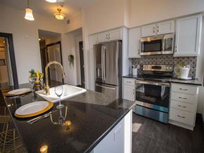 Harrisburg apartment for rent - a kitchen with stainless steel appliances and black counter tops
