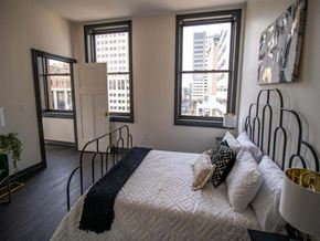 Harrisburg apartment for rent - a bedroom with a bed and a view of the city