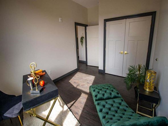 Harrisburg apartment for rent - a hotel lobby with green chairs and a glass door