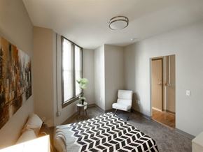Harrisburg apartment for rent - a bedroom with a bed and a chair and a window