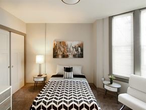 Harrisburg apartment for rent - a bedroom with a bed and two windows