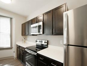 Harrisburg apartment for rent - a kitchen with stainless steel appliances and black cabinets