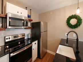 Harrisburg apartment for rent - a kitchen with stainless steel appliances and black counter tops