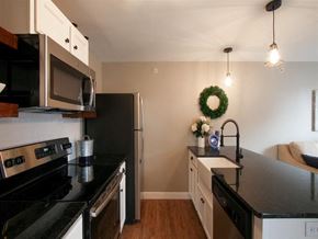 Harrisburg apartment for rent - a kitchen with black counter tops and stainless steel appliances