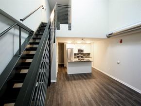 Harrisburg apartment for rent - a living room with a staircase and a kitchen