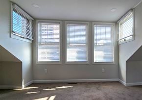 Harrisburg apartment for rent - Three windows with blinds open in a room.