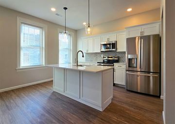 Harrisburg apartment for rent - A kitchen with a stainless steel refrigerator and wooden floors.