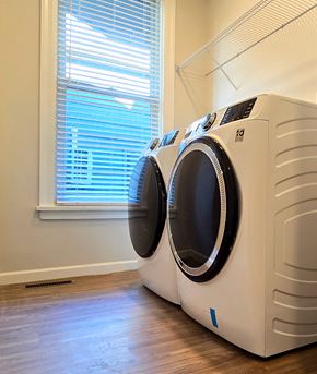 Harrisburg apartment for rent - Two front load washing machines in a laundry room.