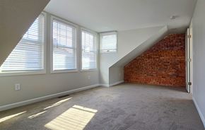 Harrisburg apartment for rent - A room with a carpeted floor and a brick wall.