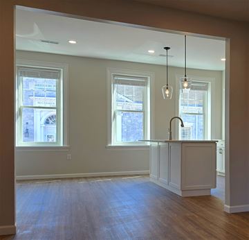 Harrisburg apartment for rent - A kitchen with a white counter and wooden floors.
