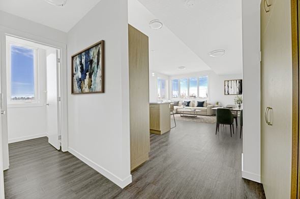 Edmonton townhouse for rent - A living room with a couch, a chair, and a painting on the wall.