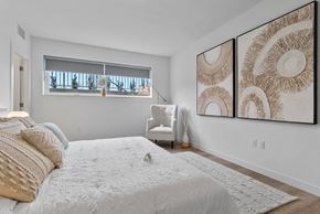 Kelowna townhouse for rent - a bedroom with a large bed and two large pictures on the wall