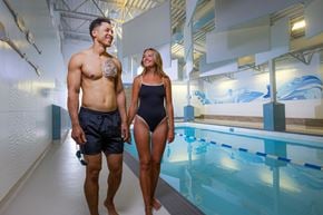 Edmonton apartment for rent - A man and a woman are walking together in a swimming pool area.