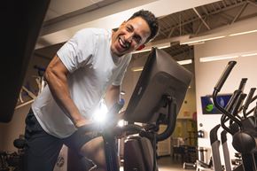 Edmonton apartment for rent - A man is exercising on a stationary bike in a gym.