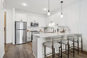 Eden Prairie apartment for rent - A kitchen with a white counter top and a stainless steel refrigerator.