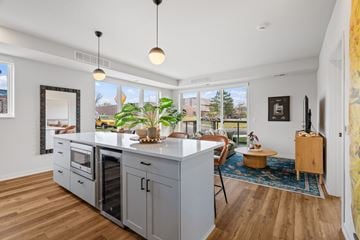 Shoreview apartment for rent - a kitchen with a large island and a living room with a table and chairs