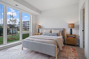 Shoreview apartment for rent - a bedroom with a bed and a large window
