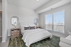Waconia apartment for rent - a white bedroom with a large window and a bed