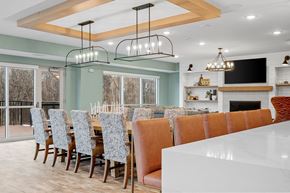 Waconia apartment for rent - a large dining room with a long table and chairs and a fireplace