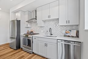 Shoreview apartment for rent - a kitchen with white cabinets and stainless steel appliances