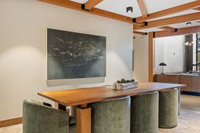 Shoreview apartment for rent - A dining room with a wooden table and green chairs.
