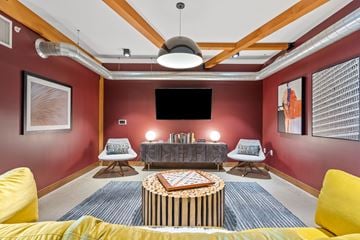 Shoreview apartment for rent - A living room with a yellow couch and a round coffee table.