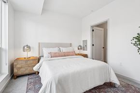 Eden Prairie apartment for rent - A bedroom with a large bed and a wooden chest of drawers.