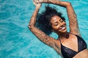 Eden Prairie apartment for rent - a woman swimming in a pool with her hands in the water