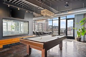 Minneapolis apartment for rent - A pool table in a room with a view of the city.