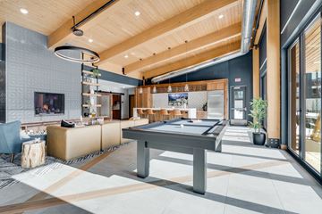 Shoreview apartment for rent - A modern living room with a pool table and a television.