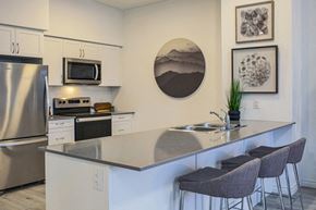 Barrie apartment for rent - Kitchen featuring quartz countertops with built-in breakfast bar at Bayfield Tower Apartments in Barrie, ON