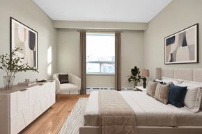 Toronto apartment for rent - A bedroom with a large bed and a chair.