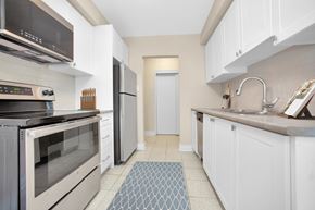 Toronto apartment for rent - A kitchen with white cabinets and a black oven.