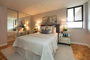 Brampton apartment for rent - 190 Cityview in Brampton, ON Bedroom with mirror door closet and two paintings above the bed