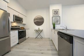 Barrie apartment for rent - Kitchen with full-size stainless steel fridge, stove, over-the-range microwave and dishwasher at Bayfield Tower Apartments in Barrie, ON