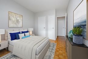 Toronto apartment for rent - A bedroom with a large bed and a painting on the wall.