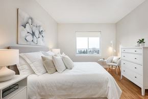 Sainte Therese apartment for rent - Bourg Du Village primary bedroom with sliding glass window and black-out blinds in Sainte Therese, QC