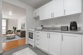 Toronto apartment for rent - A kitchen with white cabinets and a black toaster.