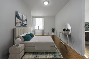 Toronto apartment for rent - A bedroom with a large bed and a painting on the wall.