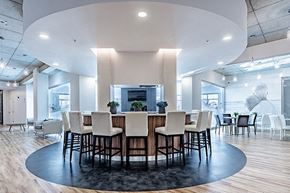 Boisbriand apartment for rent - Private kitchen with circular bar in modern social room at La Voile Broisbriand apartments in Broisbriand, Quebec