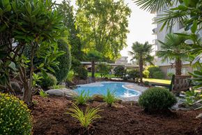 White Rock apartment for rent - Bayview Gardens Apartments outdoor pool featuring bench seating and landscaping in White Rock, BC