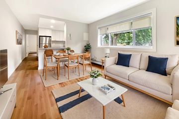 Brockville apartment for rent - A living room with a white couch and a coffee table.