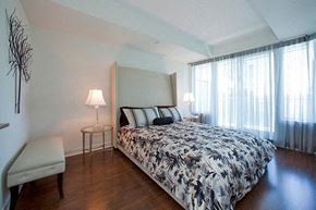 Brampton apartment for rent - Bedroom with a dogtooth pattern on the comforter of the bed at Cityview Apartments in Brampton, ON