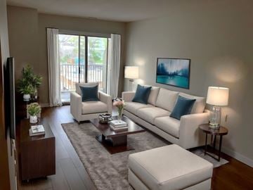 Toronto apartment for rent - A living room with a white couch, a coffee table, and a painting on the wall.