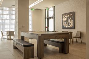 Toronto apartment for rent - social room with conference table that converts to billiards table at Junction Factory Apartments Toronto ON